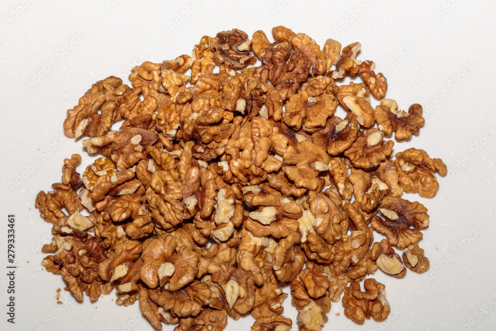 Heap kernels of walnut on a kitchen table. Concept of healthy vegan food. Heap kernels of walnut on a kitchen table. Concept of healthy vegan food.