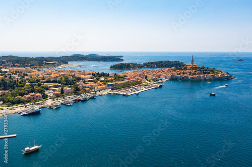 Aerial view of costal town. Aerial seaside buildings view. Aerial photo of the seashore buildings with green trees and small islands.