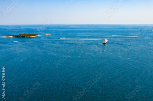 Aerial view of the ocean with some small islands on a sunny day. © magdal3na