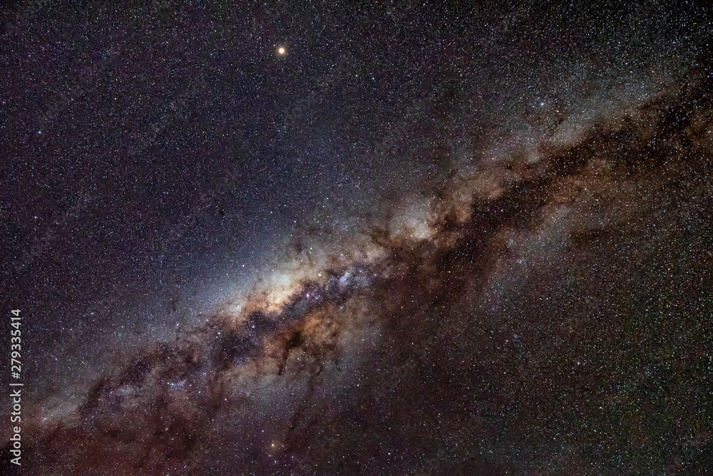 Obraz premium Milky Way Galaxy in clear night sky.The Milky Way is is a barred spiral galaxy with large group of stars that contain solar system.