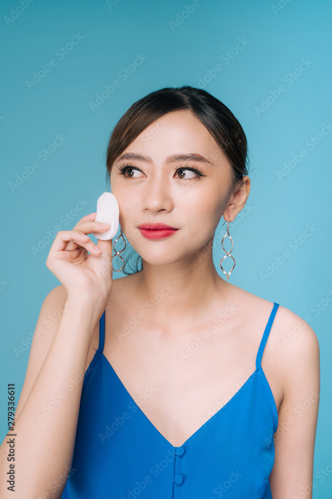 Woman using cotton pad. Happy smiling beautiful young woman cleaning skin by cotton pad. Woman using cotton pad. Happy smiling beautiful young woman cleaning skin by cotton pad.