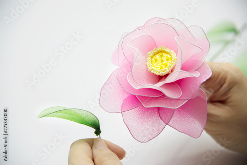 Woman making beautiful nylon flower - people with DIY handmade flower concept photo