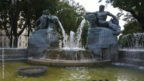 Turin, Piedmont, Italy. July 2019. Filmed with pan movement on the Angelica fountain in Piazza Solferino. The statues that compose it symbolically recall the four seasons. 30fps photo