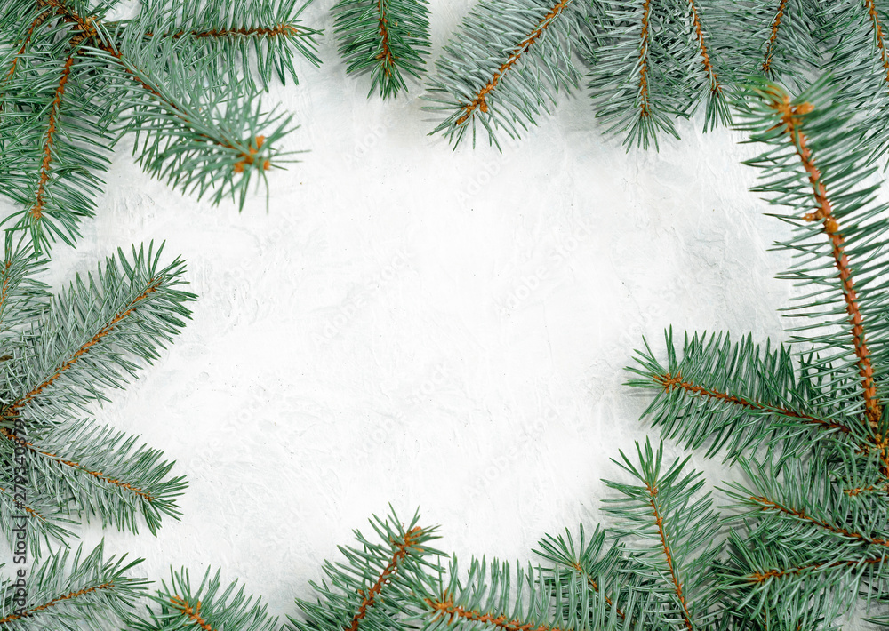 Christmas frame made of branches of a New Year tree. Christmas wallpaper. Flat lay, top view, copy space Christmas frame made of branches of a New Year tree. Christmas wallpaper. Flat lay, top view, copy space