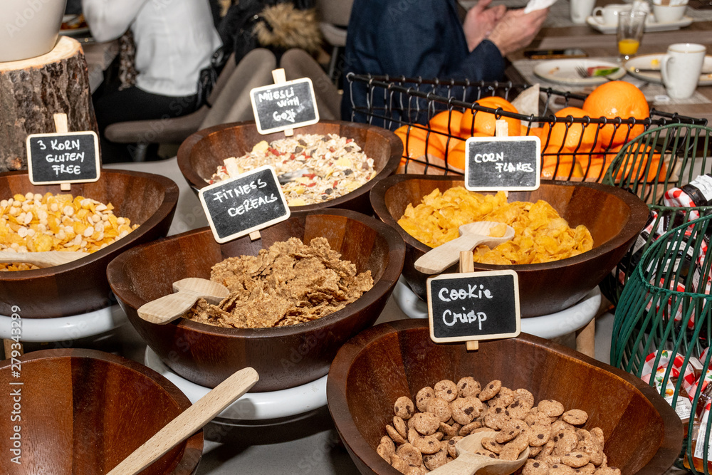 Selection of self service catering continental breakfast buffet display, catering or brunch table food buffet filled with all sorts of delicious food, cereal display in a hotel or restaurant setting