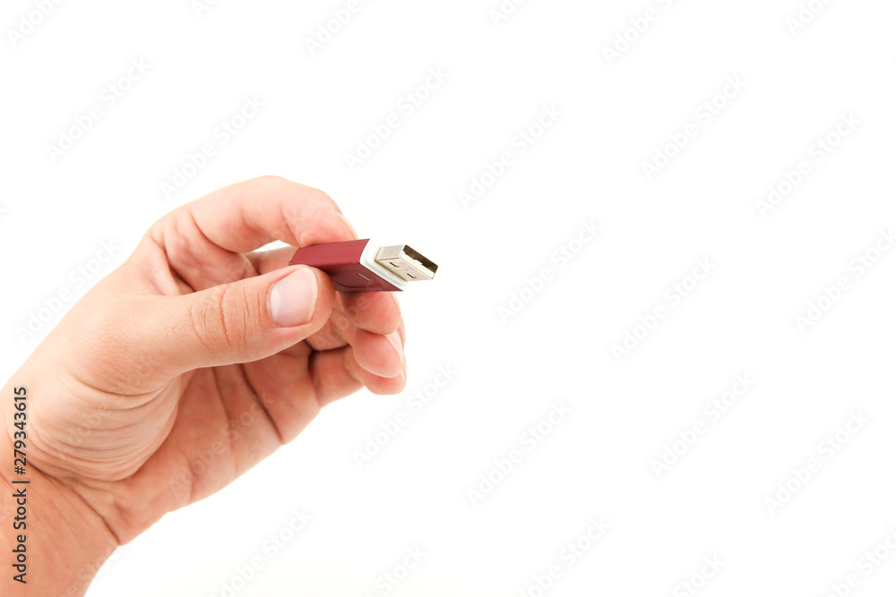 man's hand holding a usb flash drive on a white background with free space. man's hand holding a usb flash drive on a white background with free space.