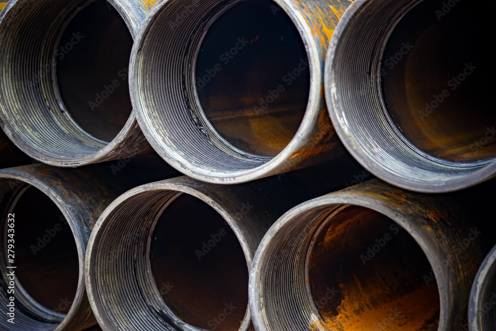 Steel Pipes bunch on the rack in warehouse. Iron pipes at shelf in warehouse. Steel Pipes bunch on the rack in warehouse. Iron pipes at shelf in warehouse.