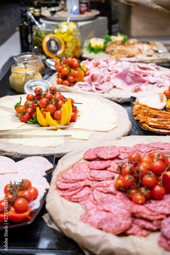 Selection of self service catering continental breakfast buffet display, catering or brunch table food buffet filled with all sorts of delicious food, meat platters in a hotel or restaurant setting