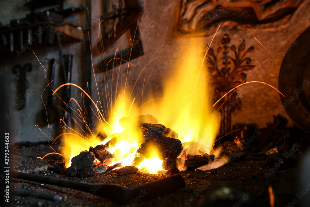 anthracite burns in the forge. the furnace in the forge. sparks fly from burning coal in a forge furnace anthracite burns in the forge. the furnace in the forge. sparks fly from burning coal in a forge furnace