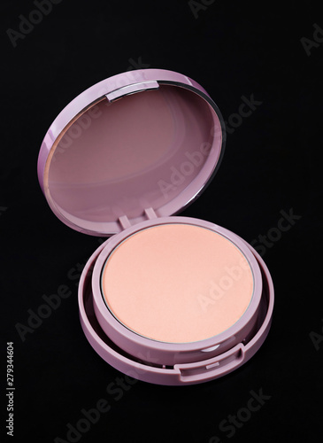 Face powder for makeup in pink container.