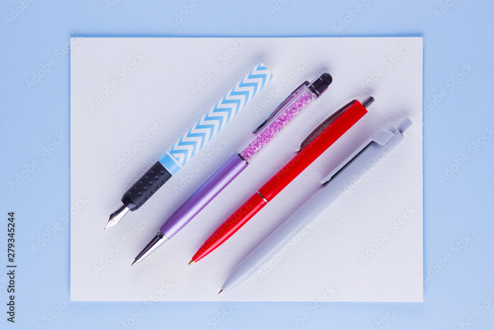 Back to school pop art concept. School stationery on pink blue background. Multicolored pens on pastel background. Flat lay. Copy space Back to school pop art concept. School stationery on pink blue background. Multicolored pens on pastel background. Flat lay. Copy space