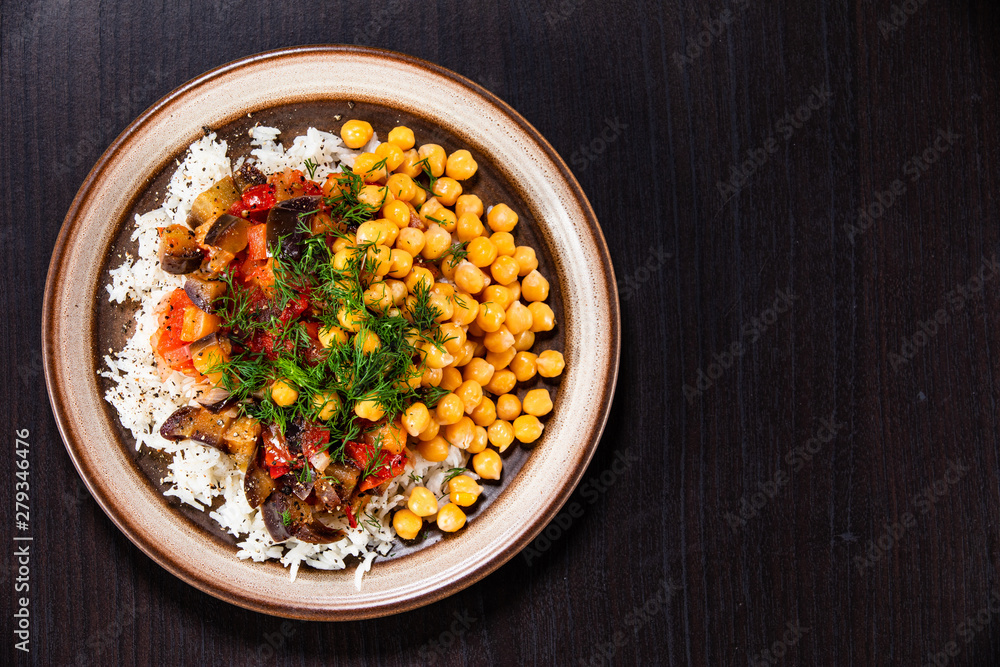 Rice with chickpea and vegetables on wooden table Rice with chickpea and vegetables on wooden table
