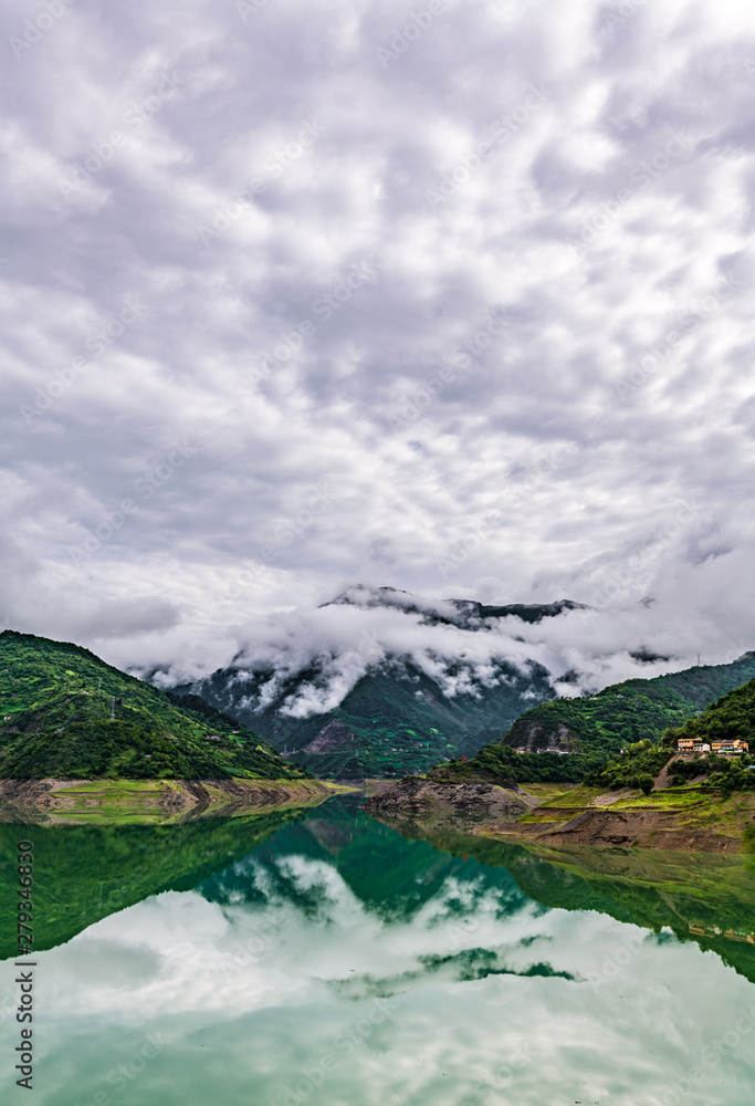 mountains and clouds and reflection in a lake