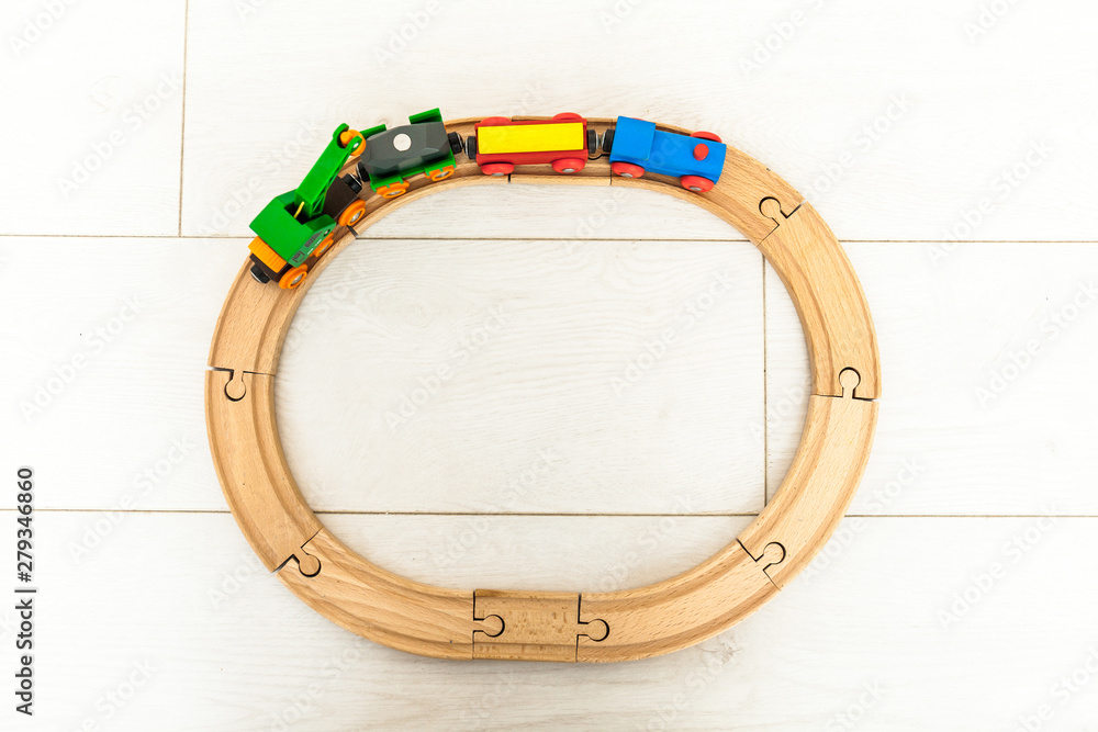 Naklejka premium Child'd wooden train on the white floor
