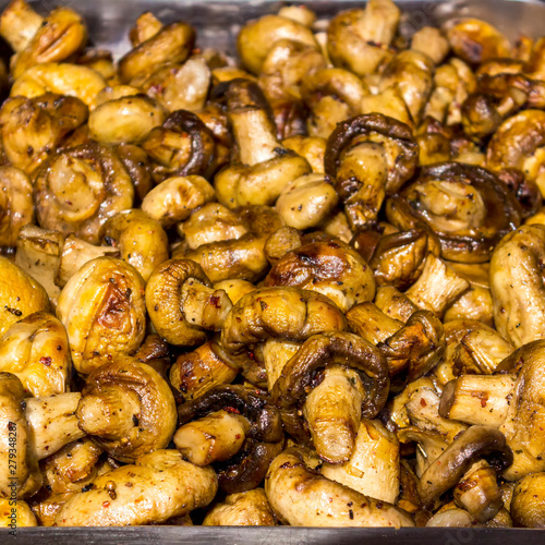 Fried champignons on the baking sheet. Close-up of fried mushrooms.
