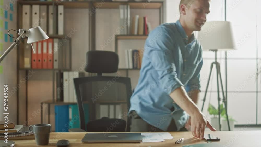 Handsome Young Entrepreneur Works in Office Closes His Laptop Computer, Picks Up Smartphone from the Desk and Leaves Work Handsome Young Entrepreneur Works in Office Closes His Laptop Computer, Picks Up Smartphone from the Desk and Leaves Work