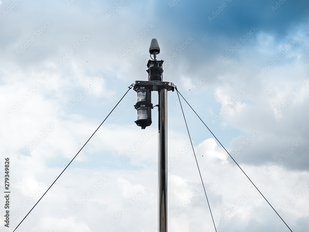 Fototapeta premium lantern on the nose of the yacht on the background of the river and the cloudy sky