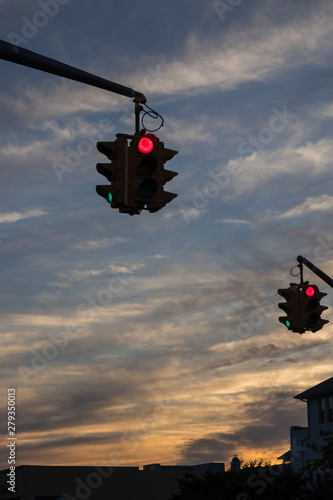 Traffic light with red light against the evening sky in USA.  Selective focus.