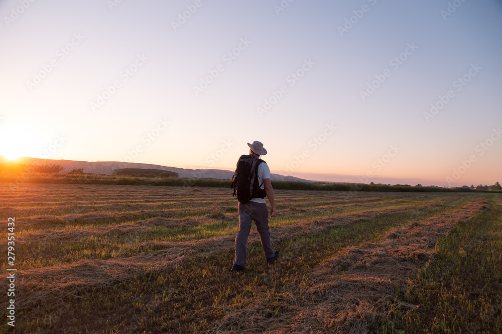backpacker traveler walking at sunrise