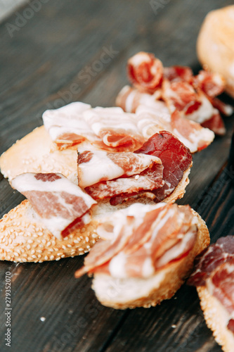 Bruschettes and a picnic with prosciutto. Italian theme in food, cheese and meat sliced.