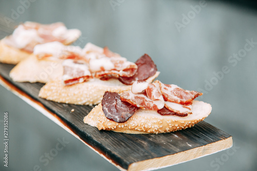 Bruschettes and a picnic with prosciutto. Italian theme in food, cheese and meat sliced.