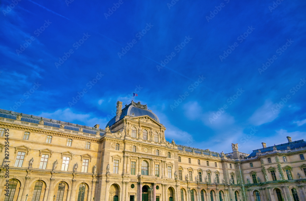 Paris, France - April 21, 2019 - A view of the Louvre Museum, the world's largest art museum and a historic monument in Paris, France, on a sunny day.