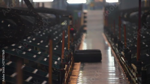 Wallpaper Mural Manufacture of automobile tyres. Car tire vulcanization shop. Conveyor belt feeds tires for sorting and checking. Finished tires on the conveyor are fed to the warehouse. Torontodigital.ca