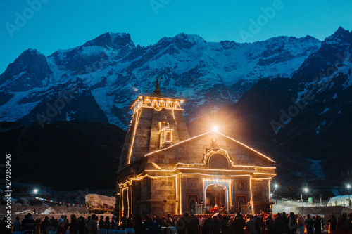 View of the Kedarnath temple lights at night with mountains in the background in Uttarakhand, India photo