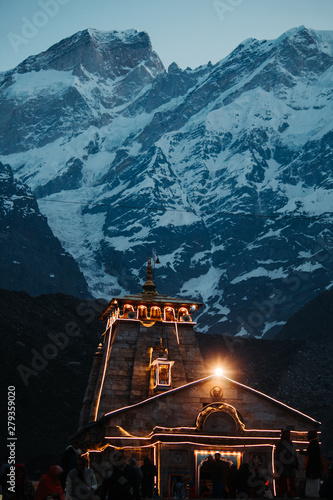 View of the Kedarnath temple lights at night with mountains in the background in Uttarakhand, India