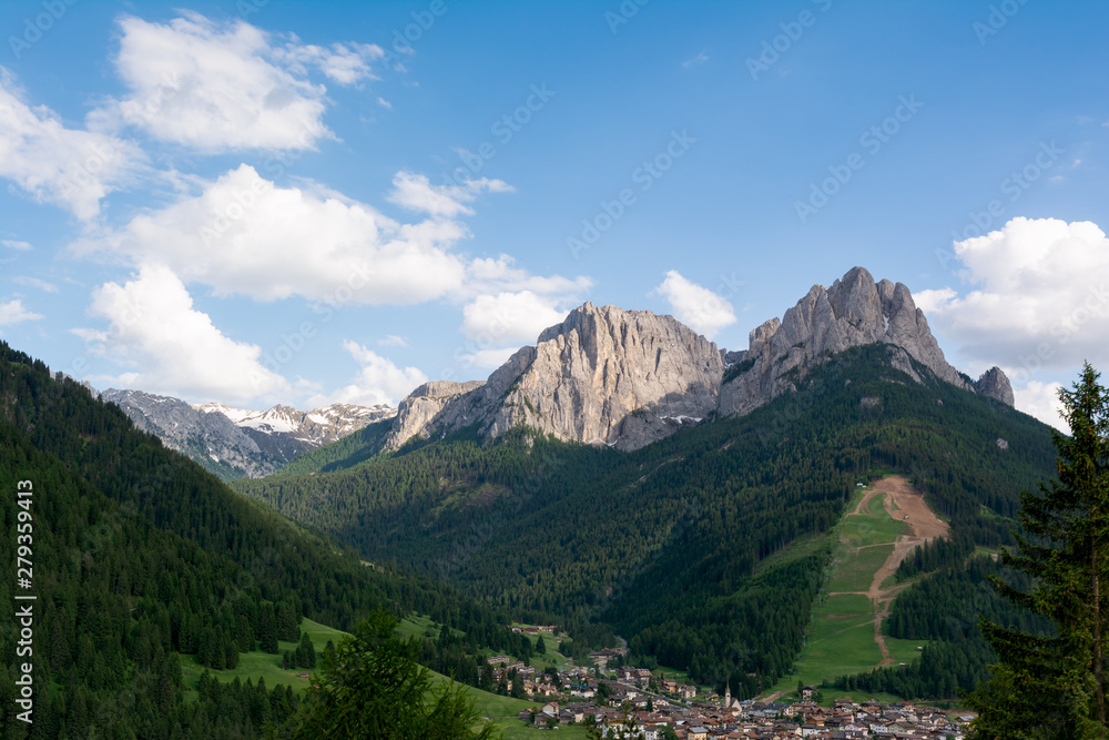 Beautiful view of Pera and Pozza di Fassa villages. Dolomites mountains on the background, Italy