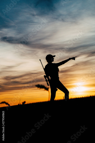 Female Hunter silhouette in Sunset. 