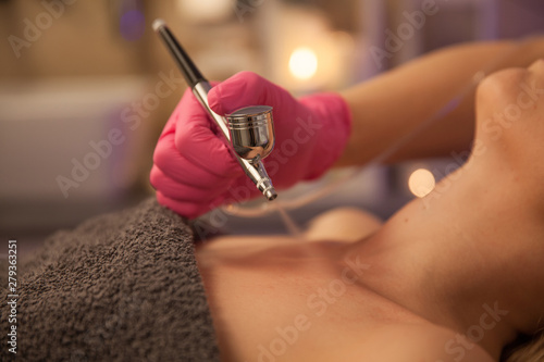 Oxygen dermapen therapy. Woman doing body treatment in beauty spa salon. 