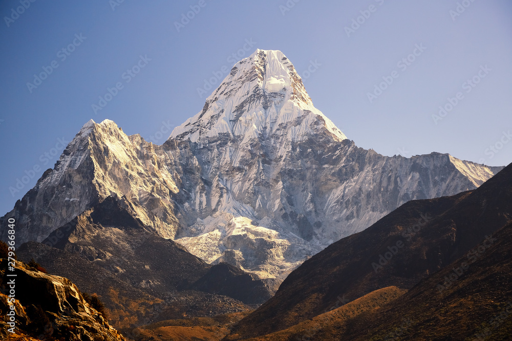 Ama Dablam massif against the blue sky in the morning.
