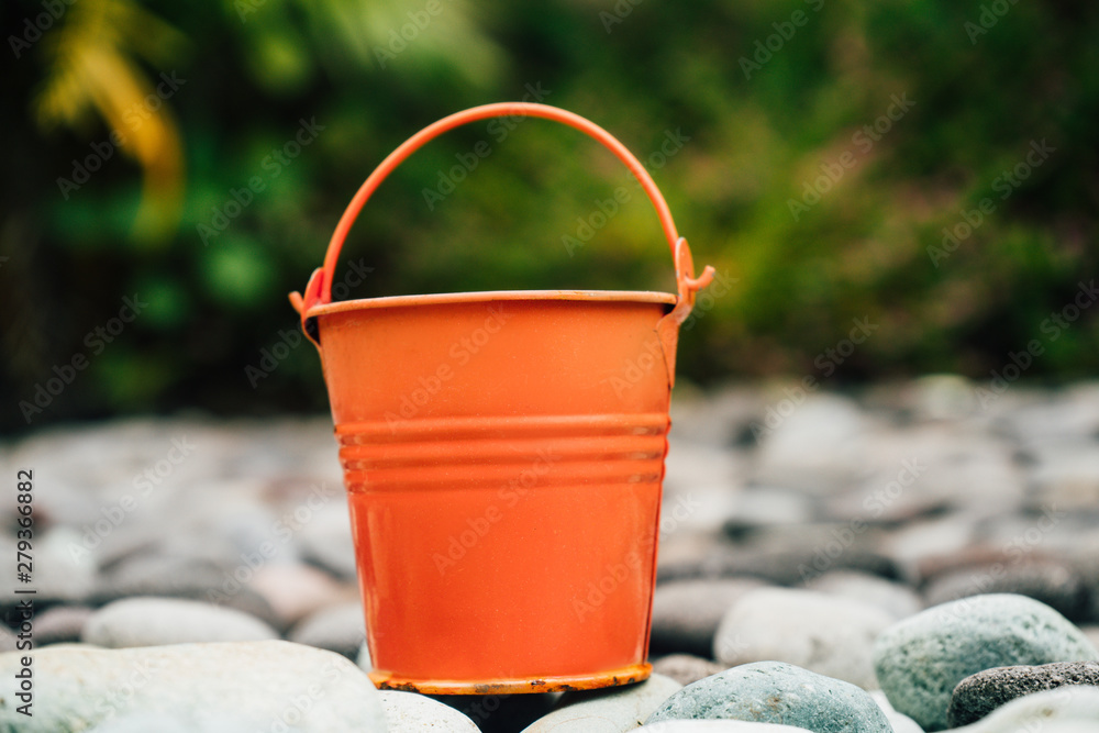 Coral watering buckets for plants in garden Coral watering buckets for plants in garden