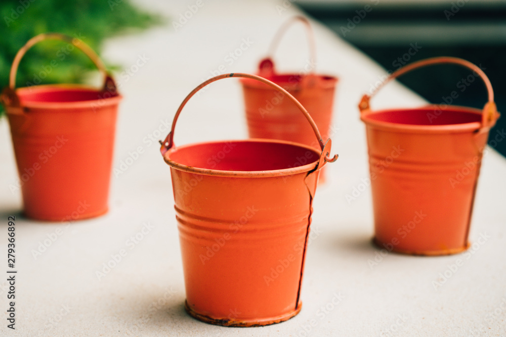 Coral watering buckets for plants in garden Coral watering buckets for plants in garden