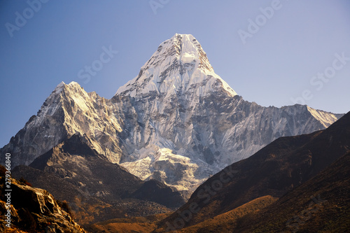Ama Dablam massif against the blue sky in the morning.