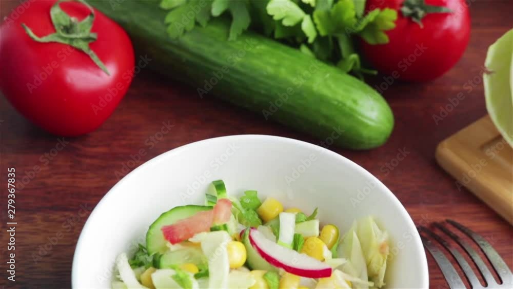 fresh salad with cabbage cucumber tomato radish corn in white bowl panning shot fresh salad with cabbage cucumber tomato radish corn in white bowl panning shot