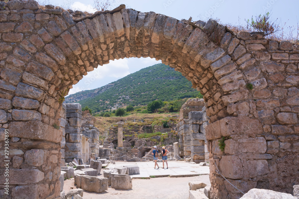 Tourists in Ephesus ancient city old ruins at sunny day, Izmir, Turkey. Turkish famous landmark