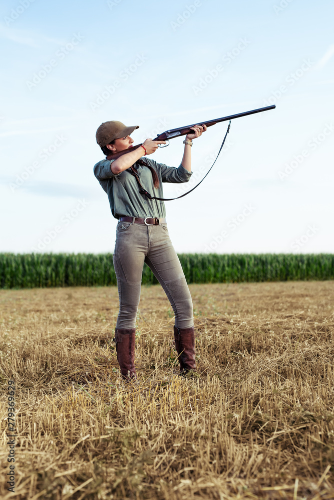 Female hunter aiming with her weapon. Female hunter aiming with her weapon.