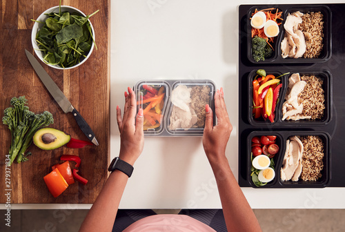 Canvas Print Overhead Shot Of Woman Preparing Batch Of Healthy Meals At Home In Kitchen