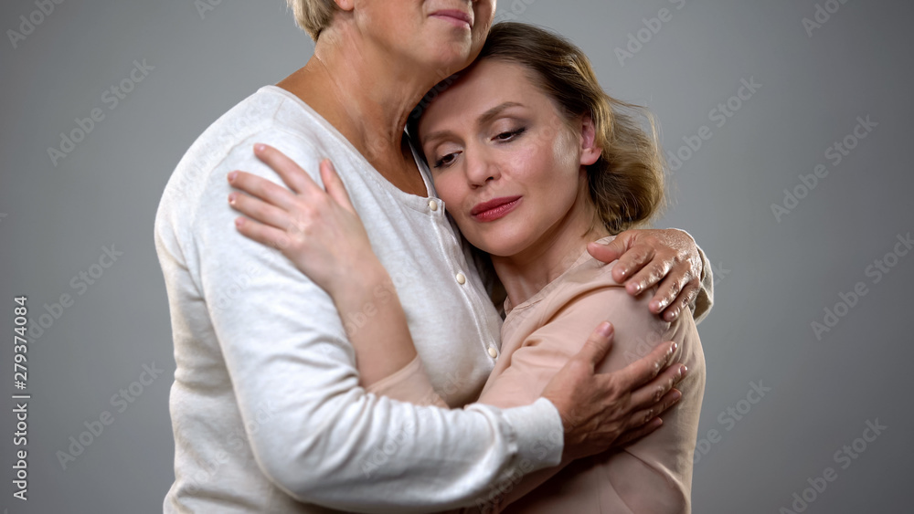 Senior lady hugging adult daughter, parenthood feeling, family understanding Senior lady hugging adult daughter, parenthood feeling, family understanding