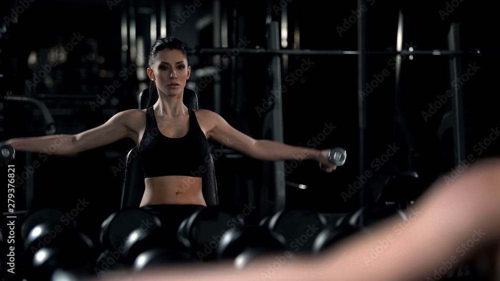 Beautiful lady doing tough workout in gym after office work, mirror reflection Beautiful lady doing tough workout in gym after office work, mirror reflection