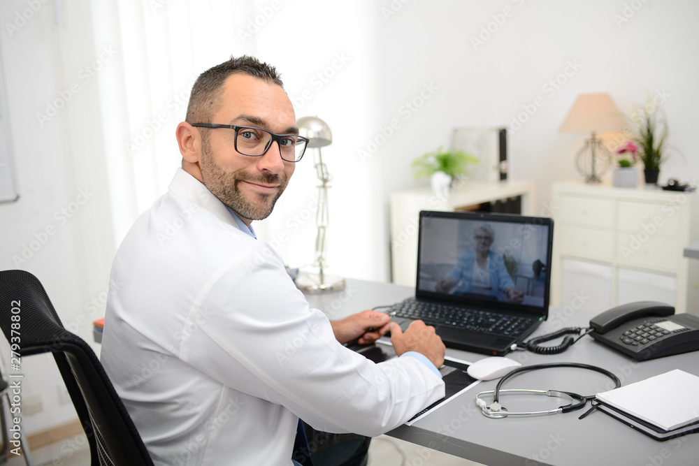 handsome doctor giving a remote medical consultation with senior woman patient over internet computer telemedecine diagnostic handsome doctor giving a remote medical consultation with senior woman patient over internet computer telemedecine diagnostic