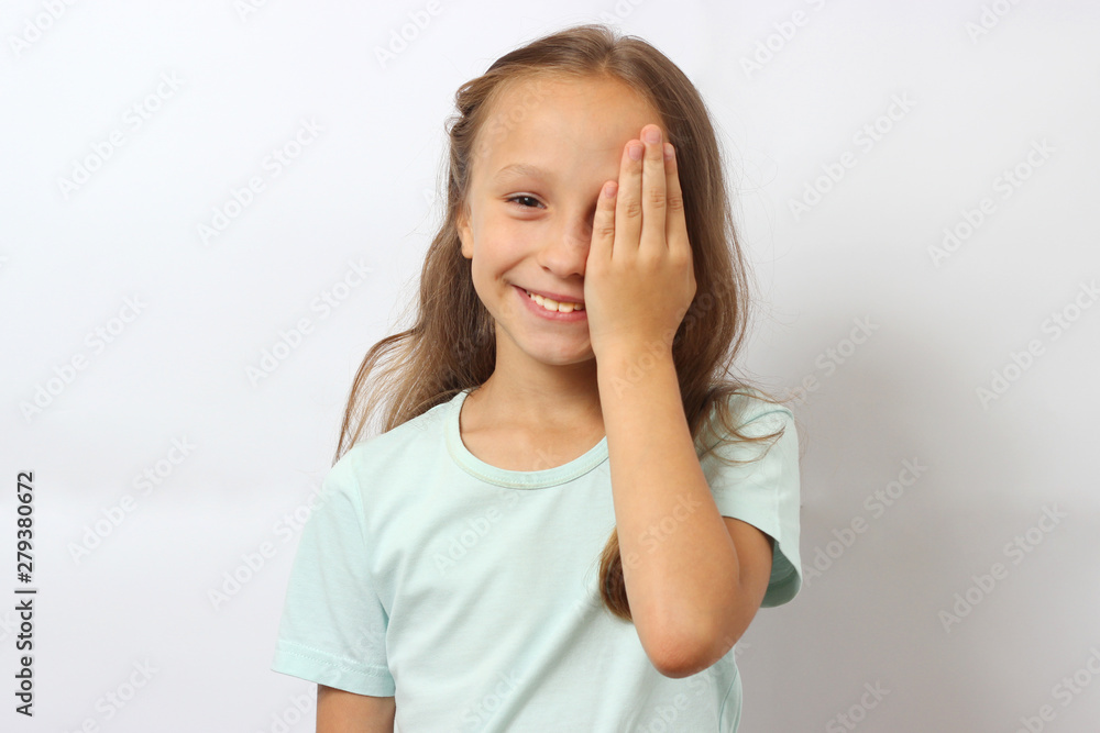 little cute cheerful girl passes an eye test in the office of an ophthalmologist little cute cheerful girl passes an eye test in the office of an ophthalmologist