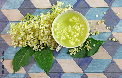 Elderflower tea on wooden background - sambucus nigra