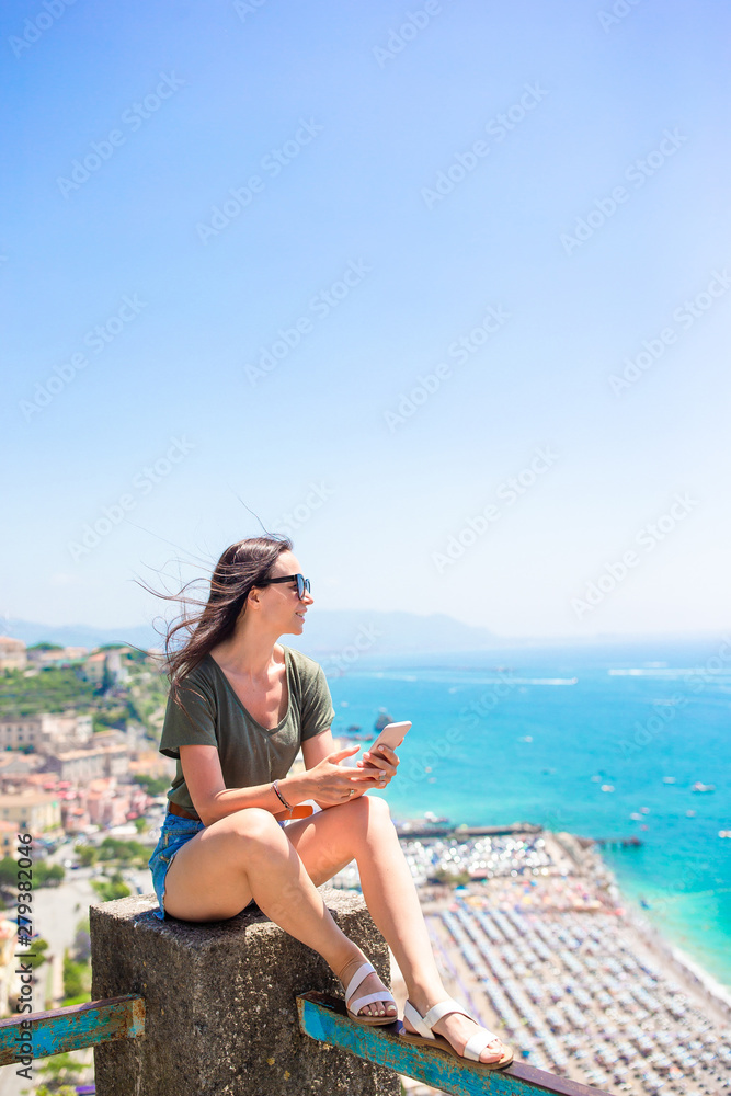 Young woman in background of mediterranean sea and sky.