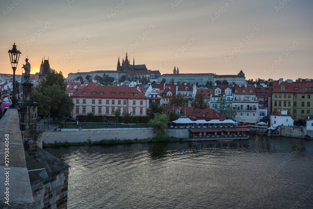 Prague Castle and Charles Bridge in the evening, Prague, Czech Republic, Vltava river in foreground.