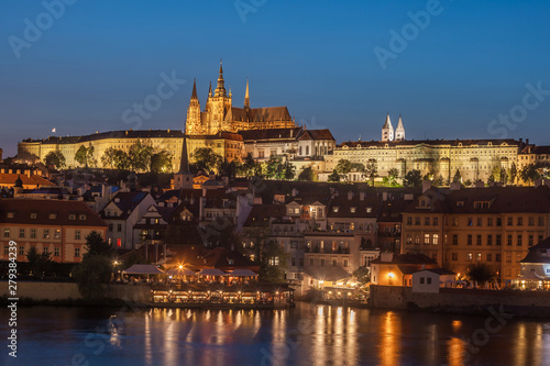 Prague Castle and Charles Bridge in the evening, Prague, Czech Republic, Vltava river in foreground.