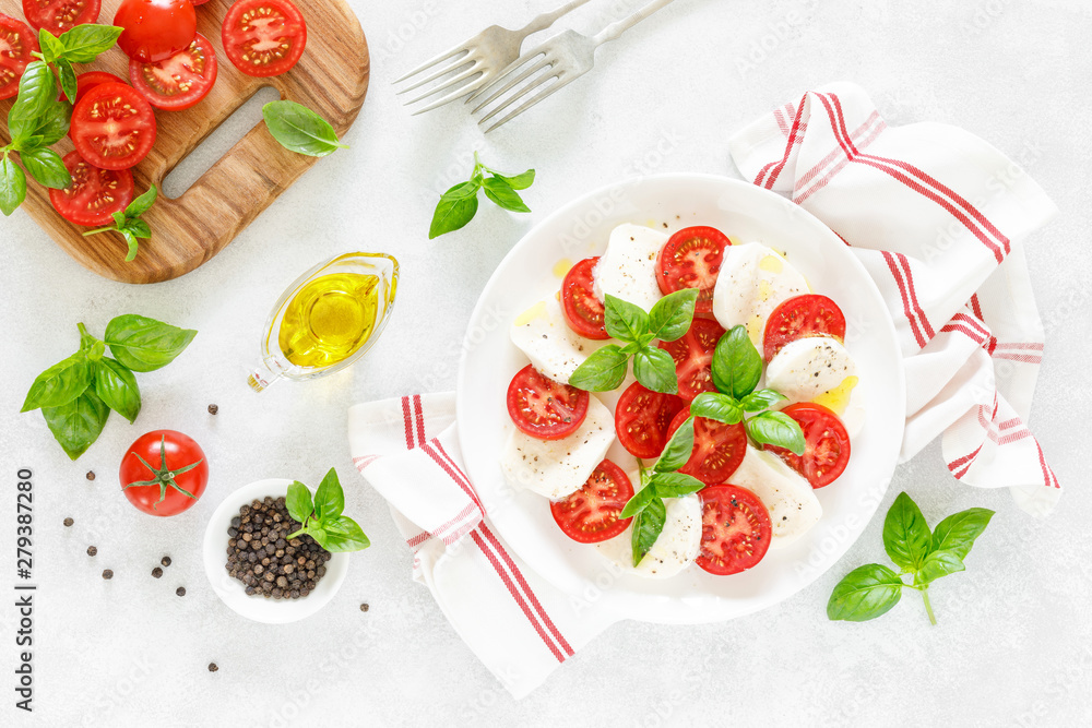 Fresh italian Caprese salad on white plate, view from above Fresh italian Caprese salad on white plate, view from above