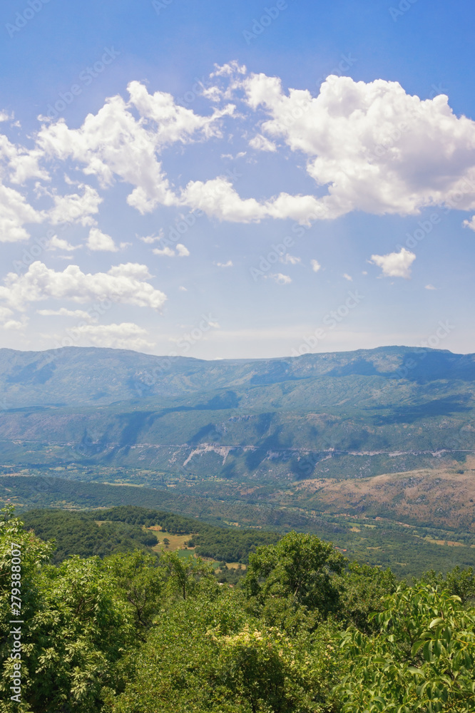 Obraz premium Beautiful mountain landscape on sunny summer day. Montenegro, Dinaric Alps, view of Bjelopavlici plain near Ostrog monastery